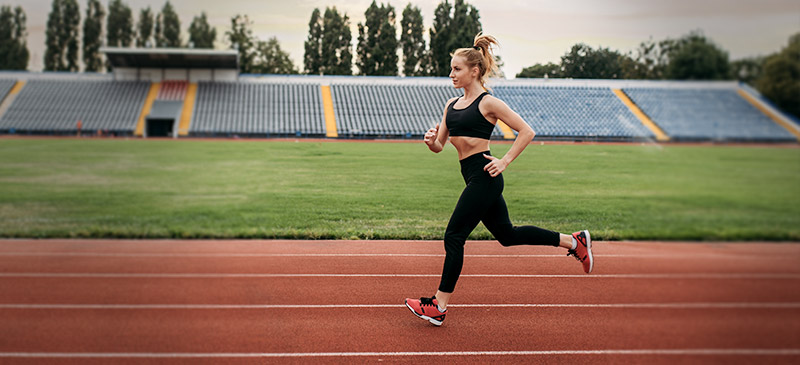 Woman running on running track